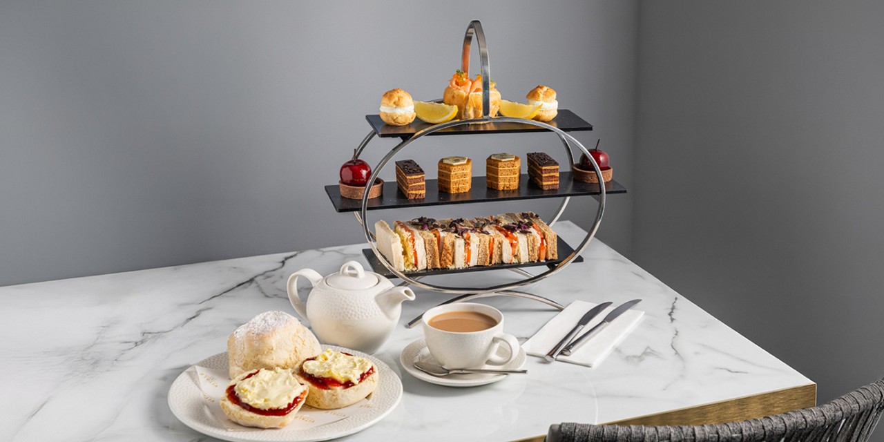 Afternoon Tea platter with fresh scones, finger sandwiches and mini cakes.