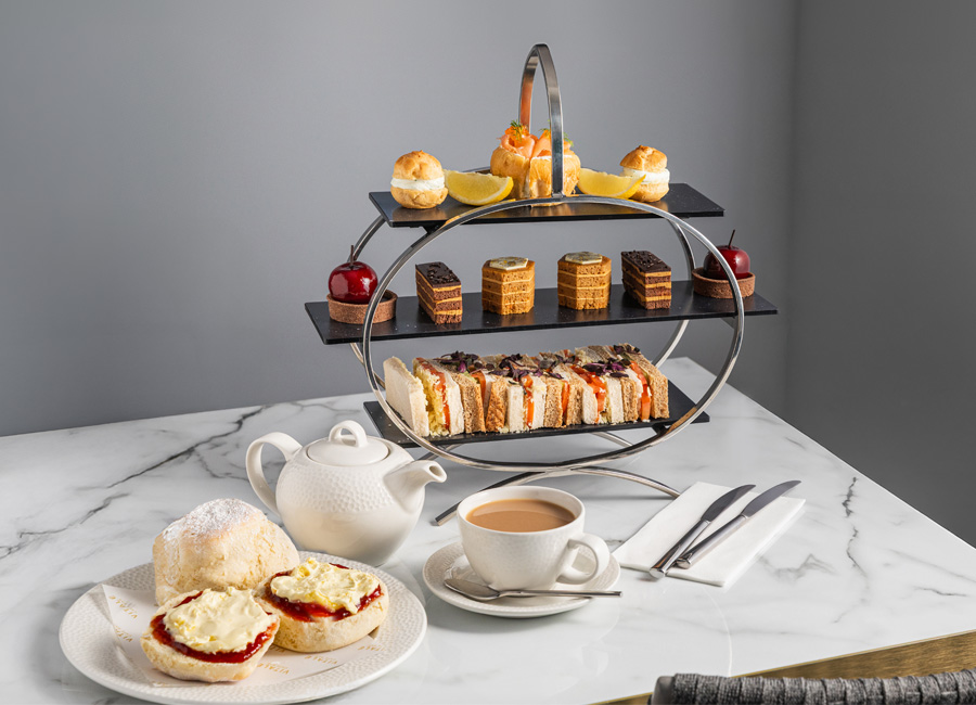 Afternoon Tea platter with fresh scones, finger sandwiches and mini cakes.