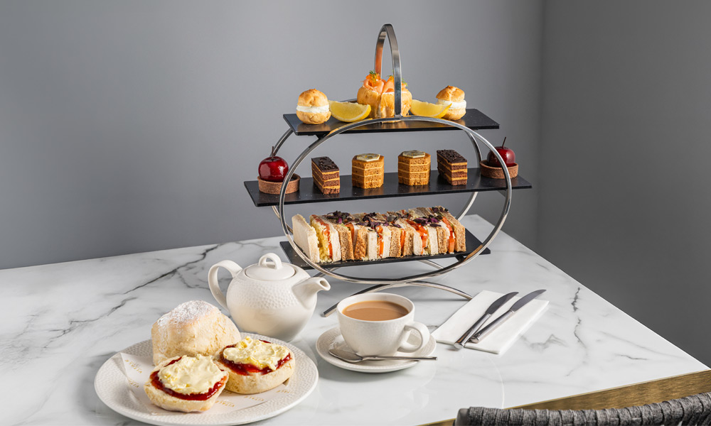 Afternoon Tea platter with fresh scones, finger sandwiches and mini cakes.