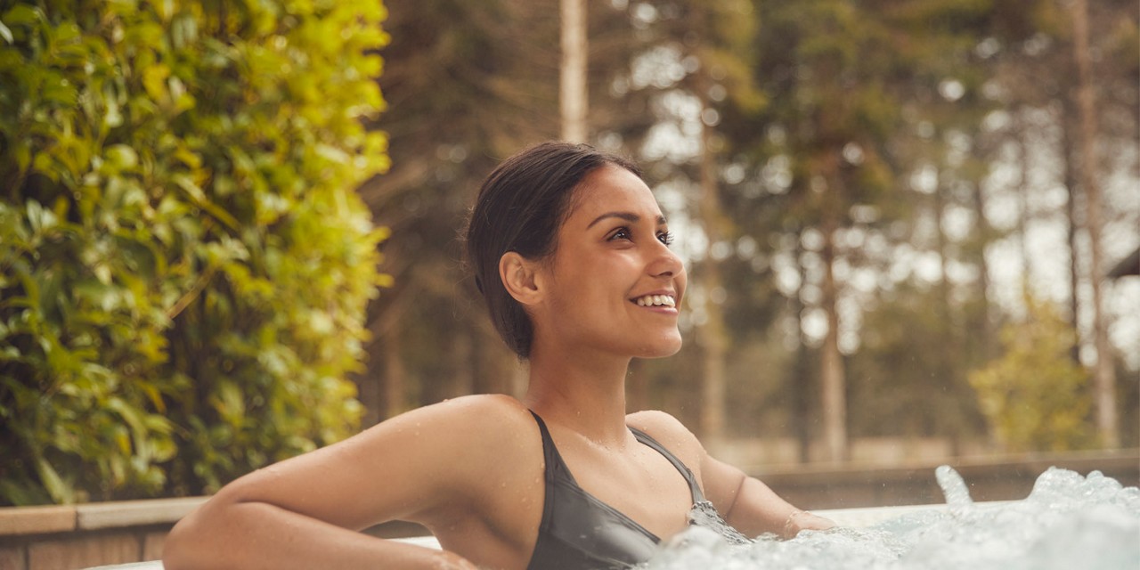 women in hot tub smiling