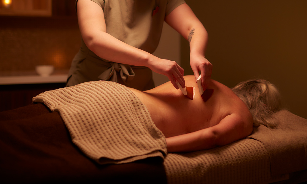 Woman having a massage with soft body brushes.