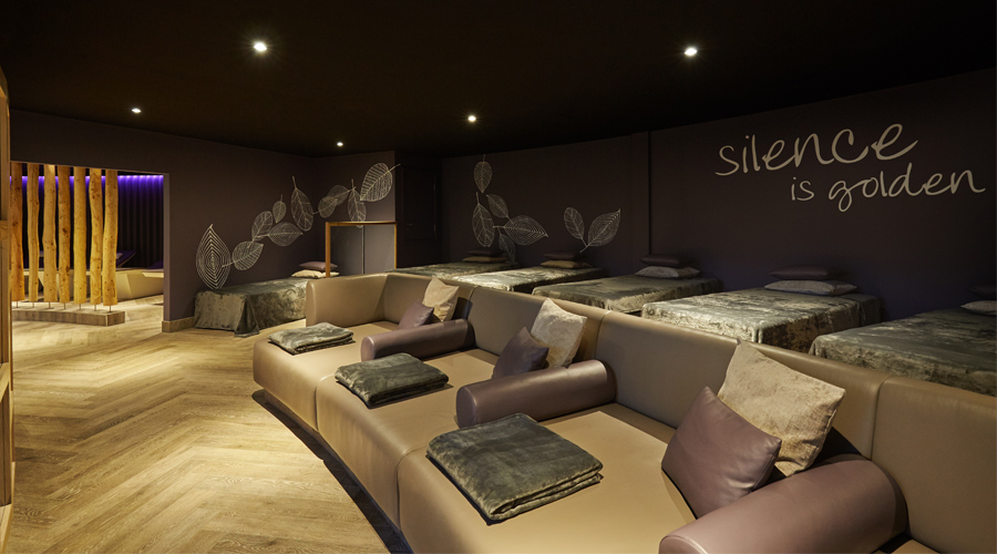 relax room with large sofa and waterbeds both with blankets