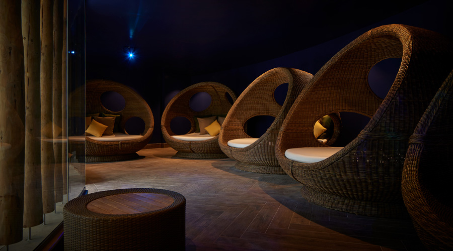 Comfortable egg chairs in a dim lit room.