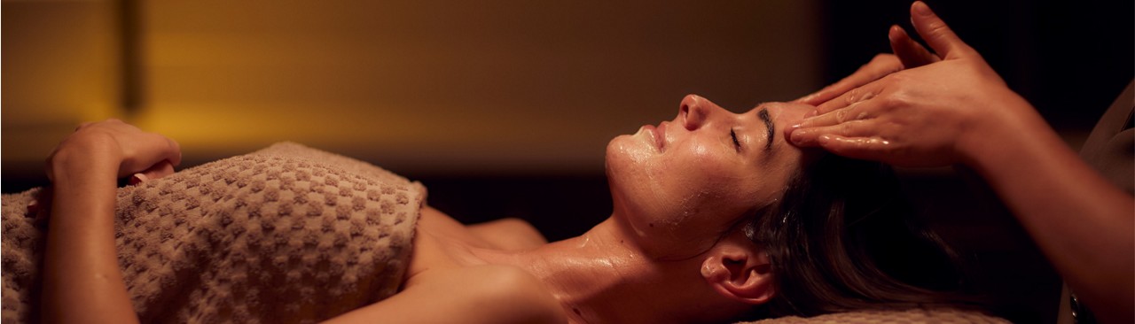 lady laid with towel on receiving facial 