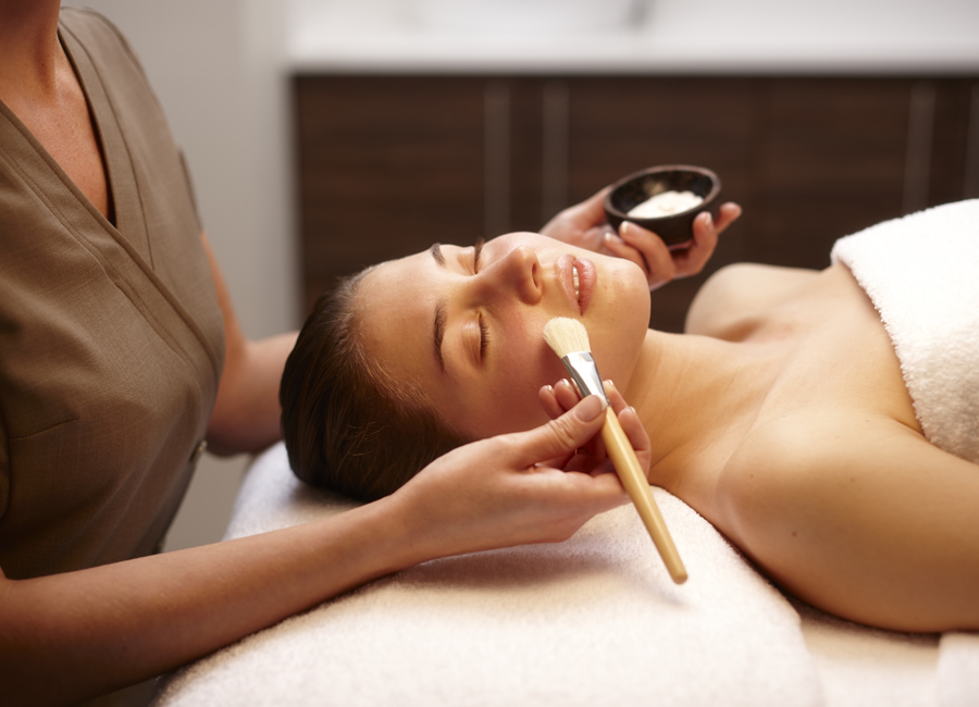 women receiving facial using a brush