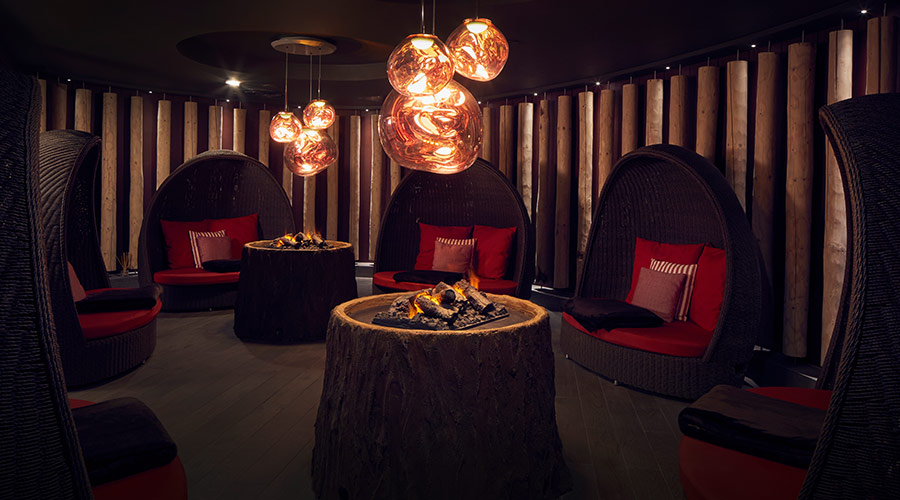 relax room with fire and lounge chairs with blankets