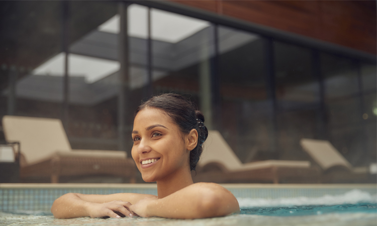 women leaning on the edge of the pool