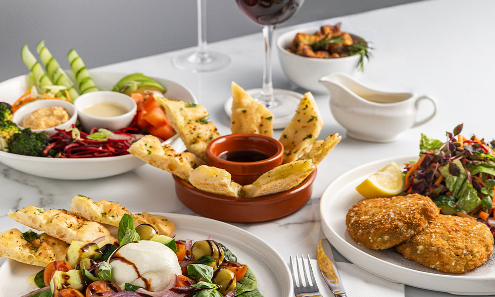 A selection of dishes including fishcakes and salad.