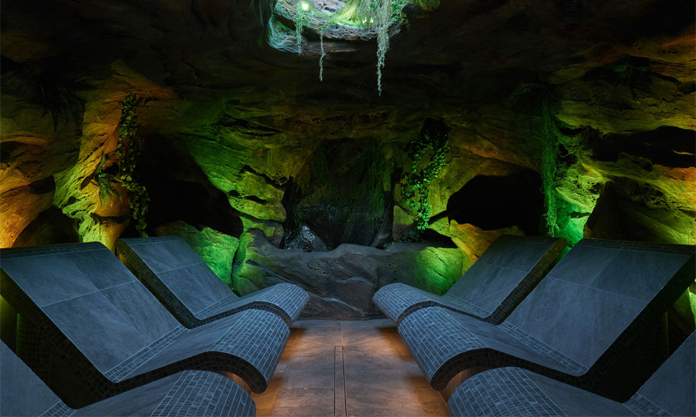 Inside a forest cavern with contoured seating.