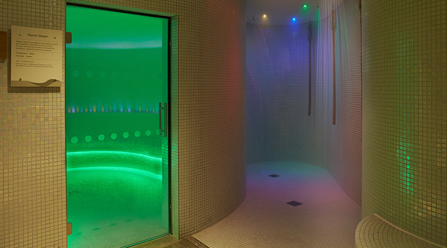 tiled shower with ropes hanging to turn the shower on