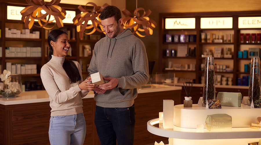 Couple looking at VOYA products inside the Forest Spa Boutique.