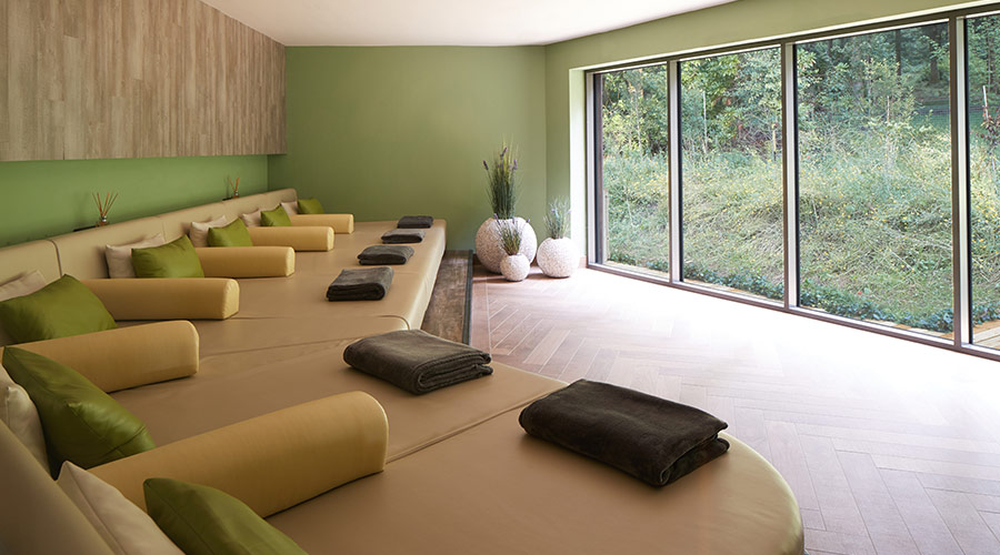 relax room with large sofa and pillows with forest view