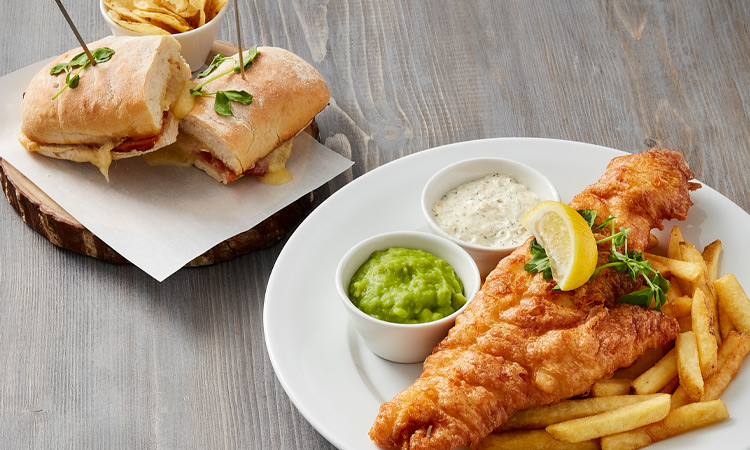 Fish and chips served with mushy peas.
