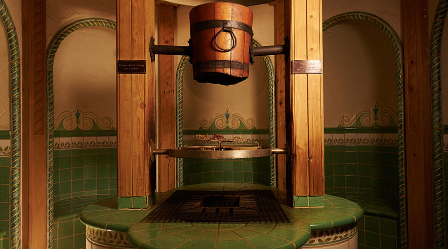 tiled experience room with bucket in the middle