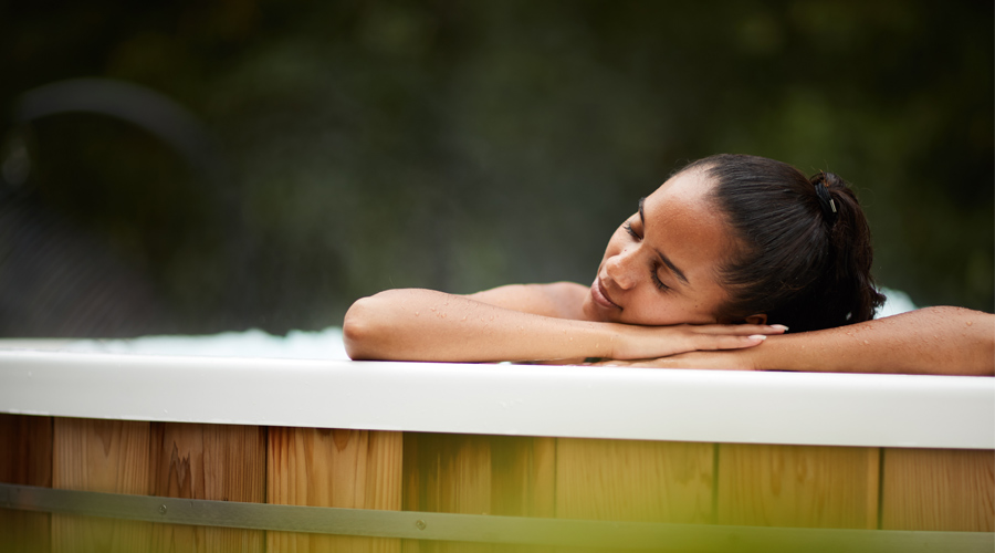 woman leaning on side of hot tub