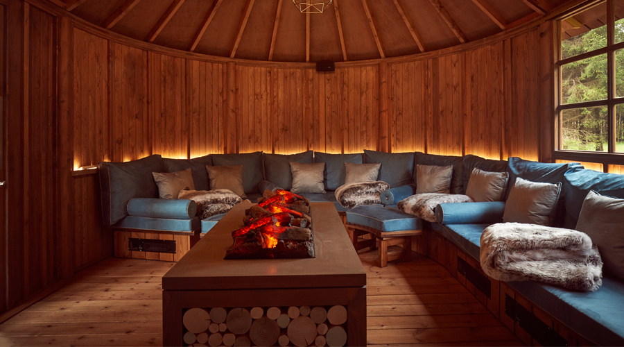 wooden snug with sofa with pillows and blankets