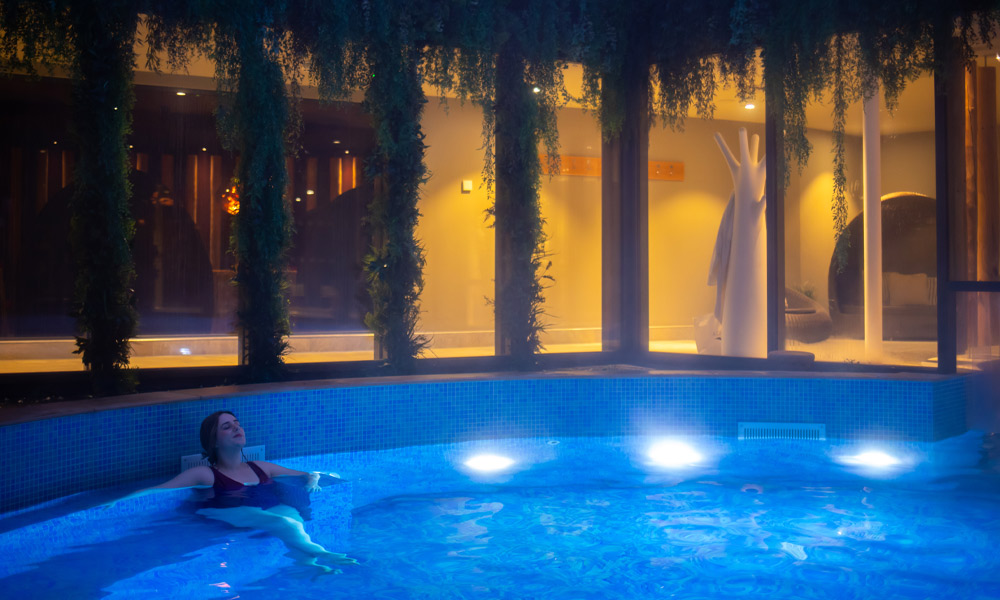 Woman soaking in an outdoor pool. 