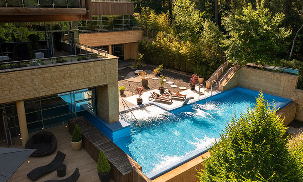 Outdoor pool surrounded by the forest.
