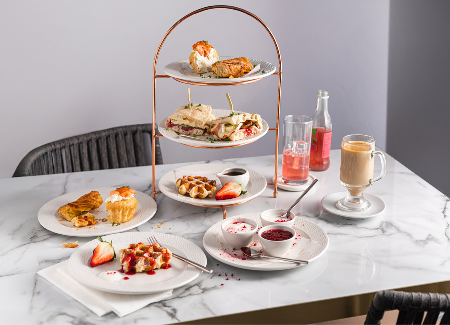 Breakfast platter stack with waffles, flatbreads and pastries.