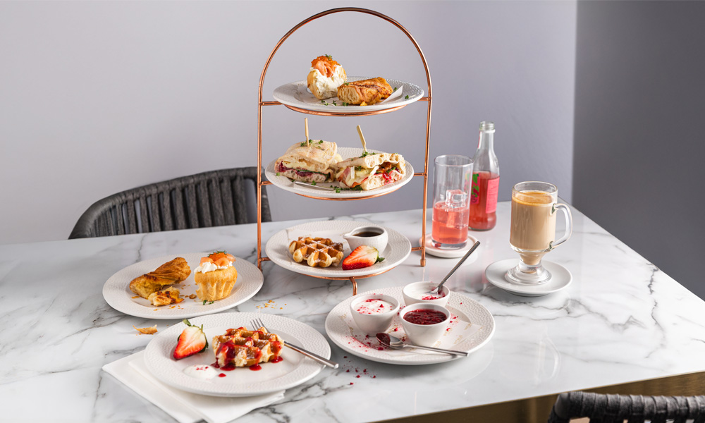 Breakfast platter stack with waffles, flatbreads and pastries.