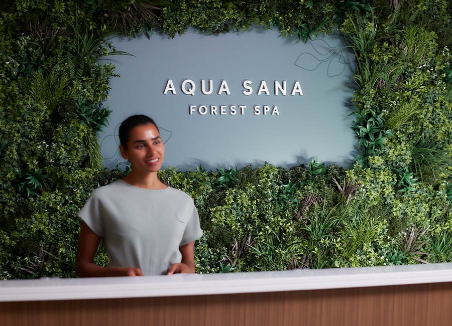 Staff member stood at the reception of Aqua Sana Forest Spa.