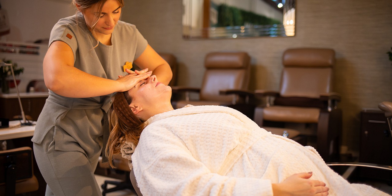 Woman laid back in the express treatment area having a facial.