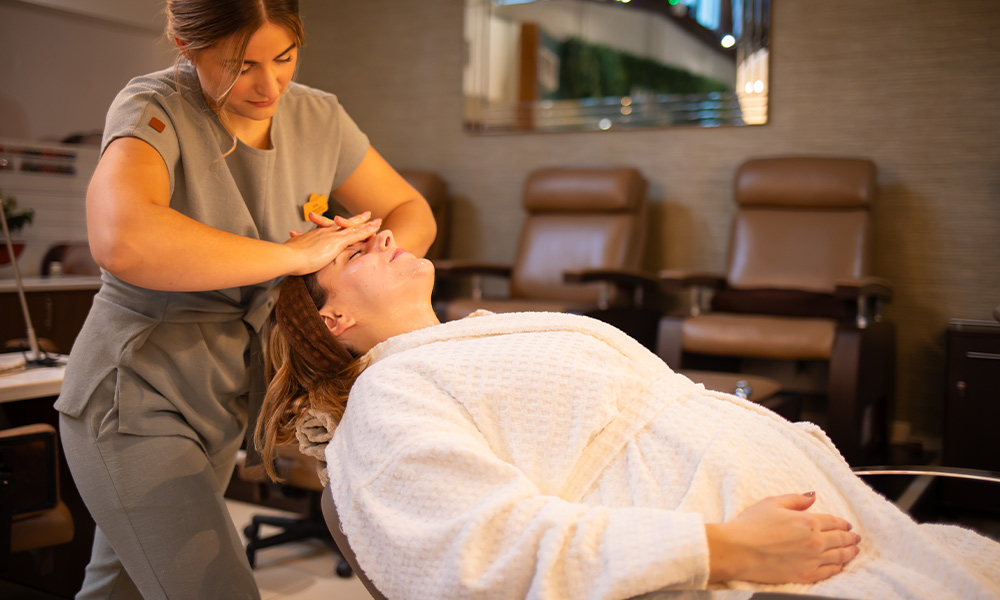 Woman laid back in the express treatment area having a facial.
