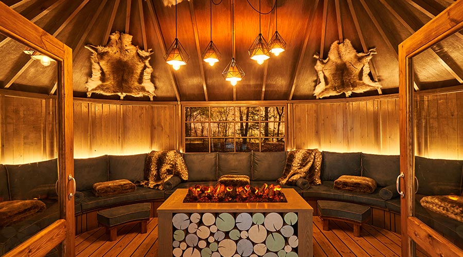 wooden snug with sofa with pillows and blankets