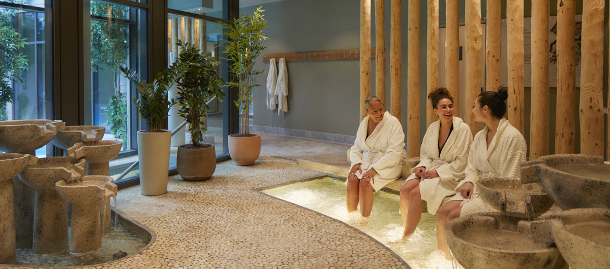 Group soaking their feet in a bubbling foot spa.