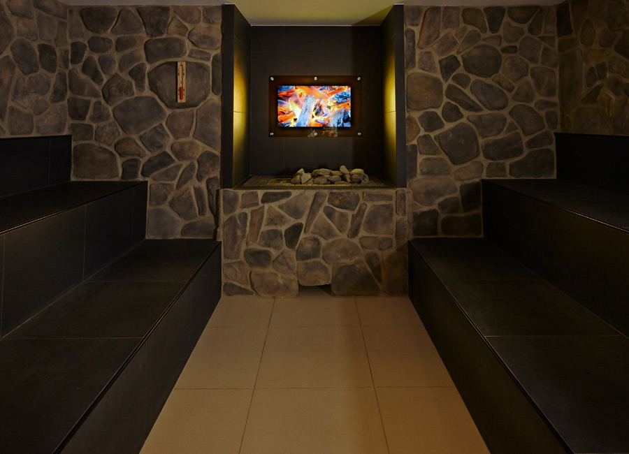 Inside the stone sauna with bench seating.