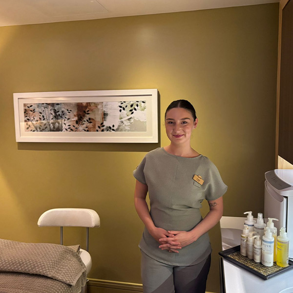 Beauty therapist standing in a treatment room