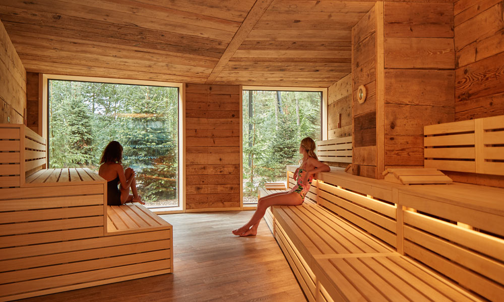 Two women sitting inside the Nordic Sauna
