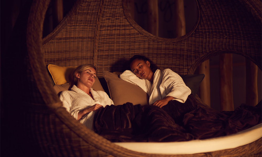 Two women lounging in a relax area.