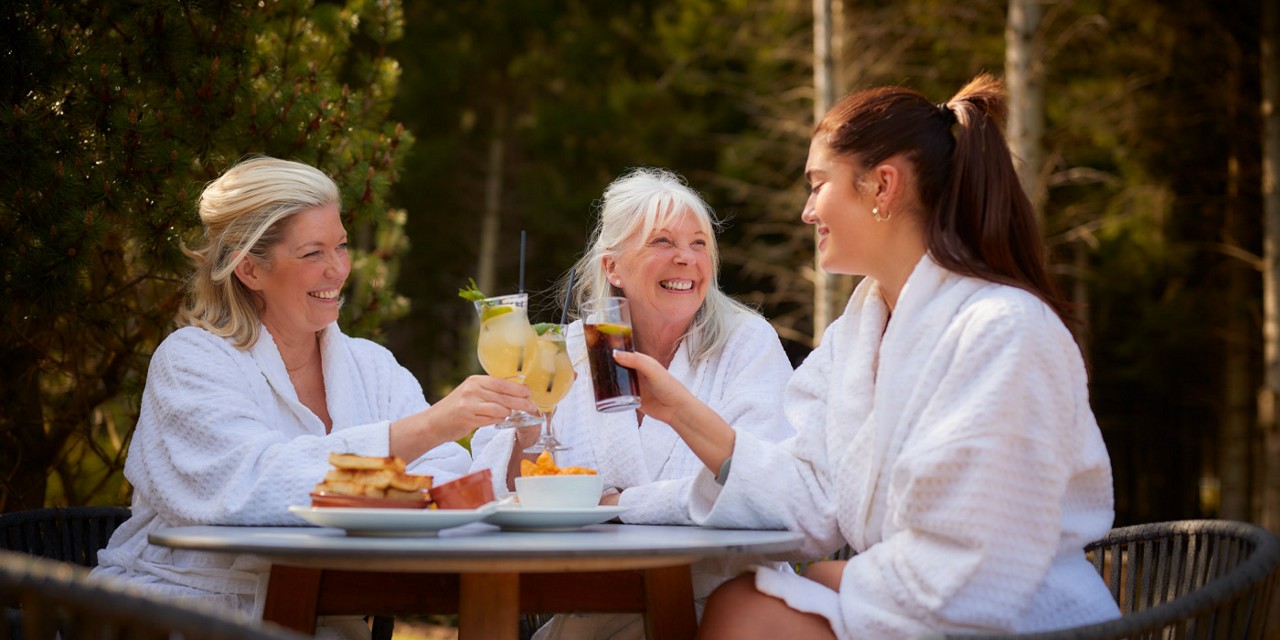 Group of ladies enjoying drinks in the forest.