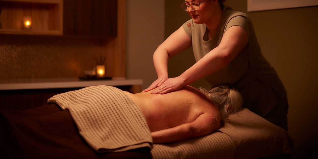 Woman having a back treatment with VOYA products.
