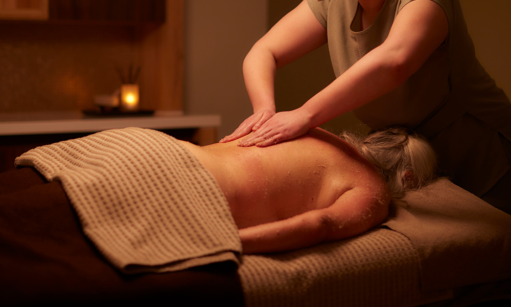 Woman having a back treatment with VOYA products.