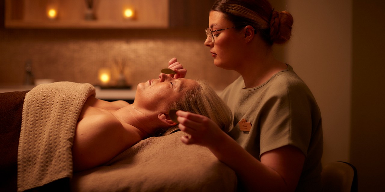 Woman having a body treatment with VOYA products.