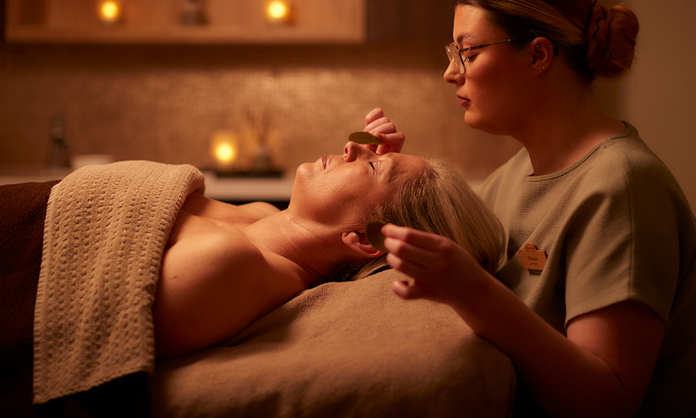 Woman having a body treatment with VOYA products.