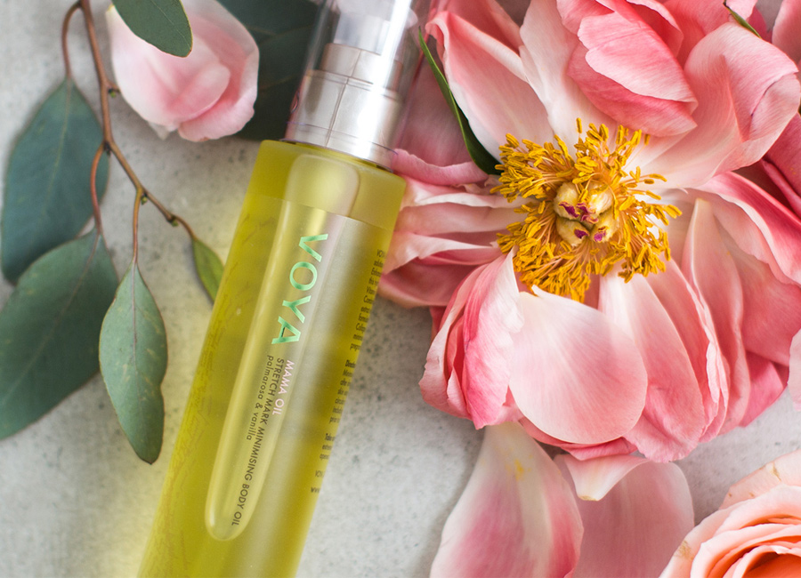 voya body oil laid on a flower