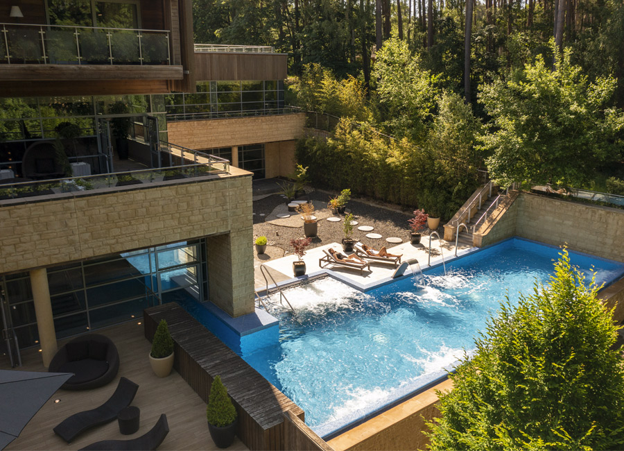 exterior view of spa with outdoor pool 