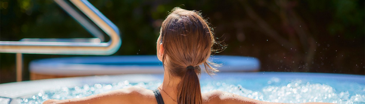 Woman sitting in a bubbling hot tub